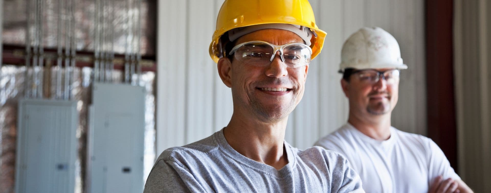Two workers in hard hats on a George T. Weldon Construction job site